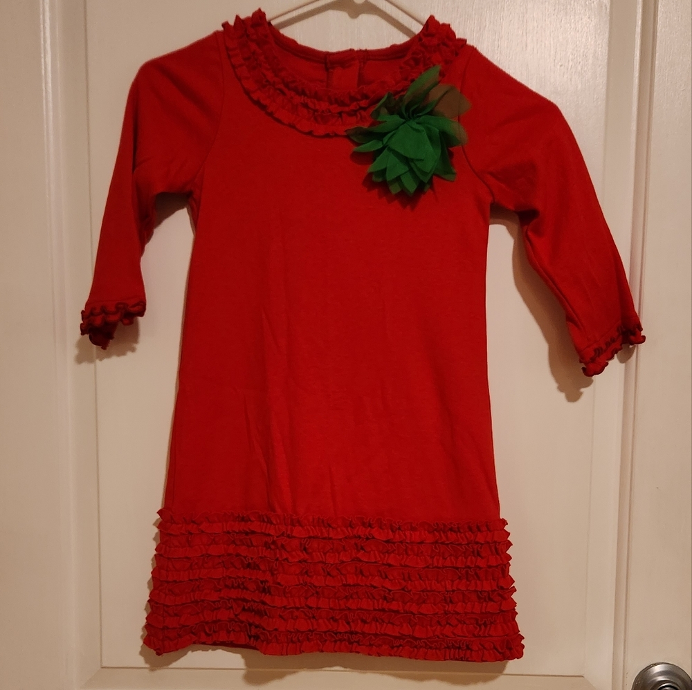 Girls holiday red dress complete written ruffles and embellished with a flower
